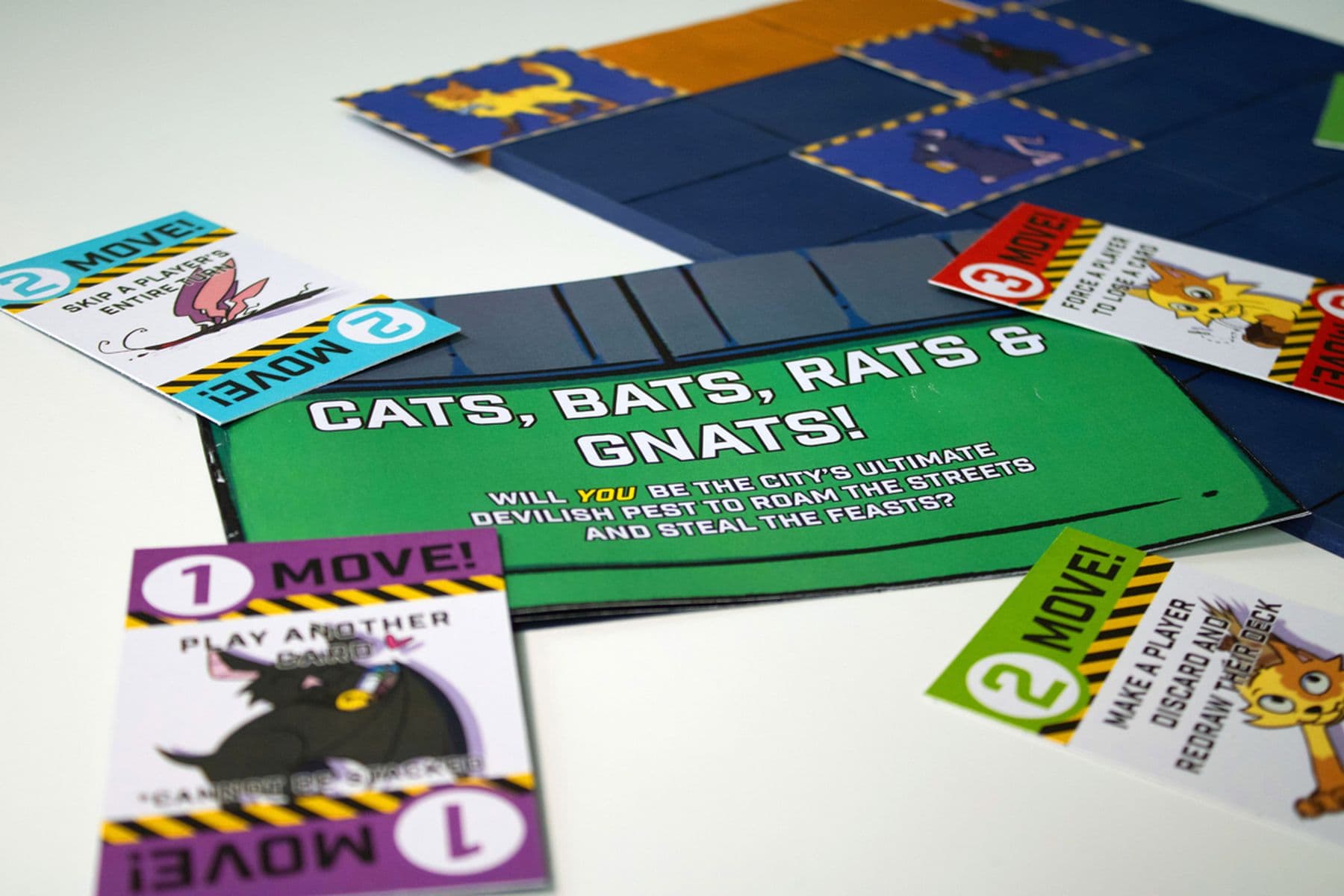 An image of a board game featuring colourful cards with the title:  Cats, Bats, Rats, and Gnats.