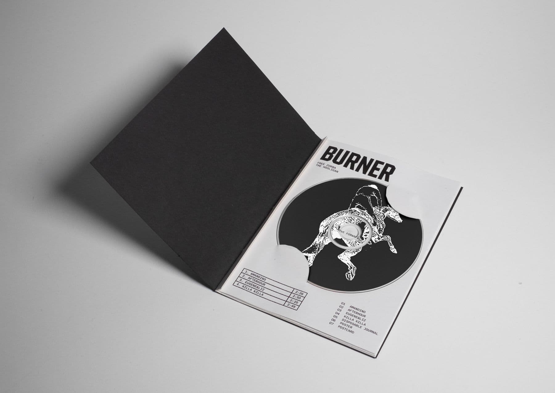 A photo of a printed magazine titled Burner. The magazine is black and white and there is a CD in the centre with an illustration of someone riding a rearing horse.