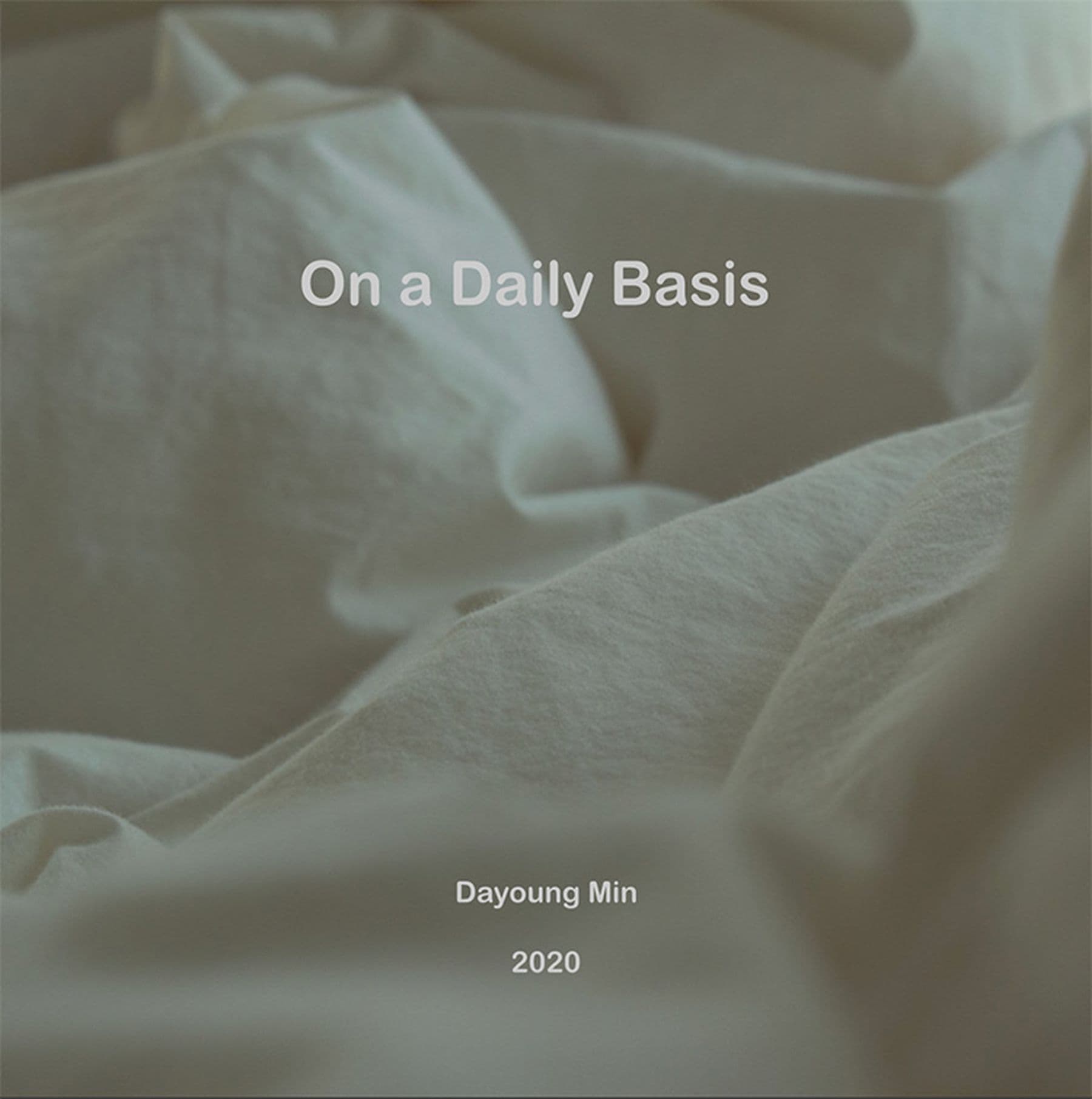 A photograph of a soft, crumpled white sheet with text that reads: 'On a Daily Basis' and 'Dayoung Min 2020' overlaid.